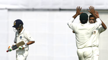 India's Gautam Gambhir (left) leaves the field as Bangladesh's Rubel Hossain (2nd from right) and Shafiul Islam celebrate his dismissal
