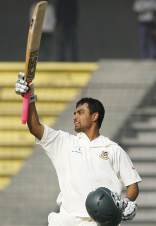 Bangladesh's Tamim Iqbal celebrates after he scored a century during the third day.