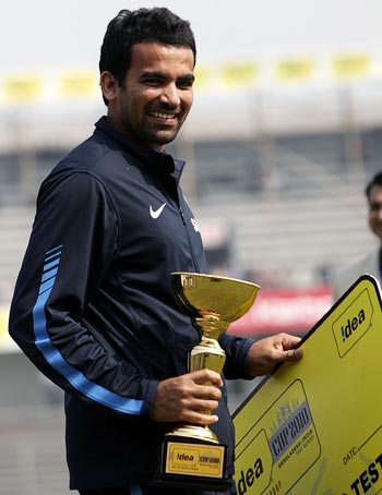 Zaheer Khan holds the man of the match trophy