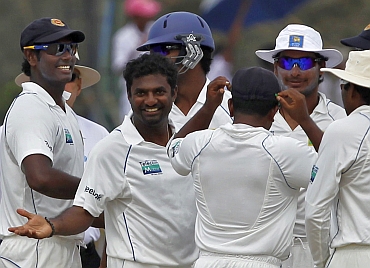 Muttiah Muralitharan celebrates with team-mates after picking Harbhajan Singh