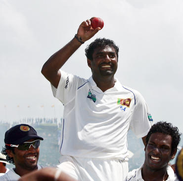Muralitharan shows ball as team mates carry him on their shoulders in Galle