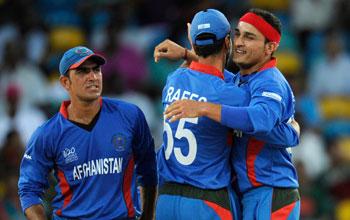 Afghan players celebrate after a fall of a wicket