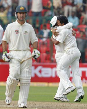 Ponting walks back as Sehwag hugs Raina on claiming his maiden Test wkt