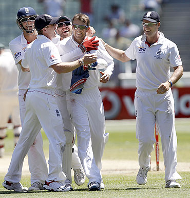 Graeme Smith celebrates with teammates after taking a wicket during the Ashes Test in Melbourne
