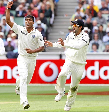 Umesh Yadav (left) celebrates with team-mate Virat Kohli after getting the wicket of Ricky Ponting