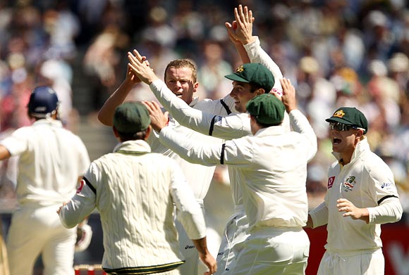 Peter Siddle is congratulated by team-mates after getting the wicket of VVS Laxman