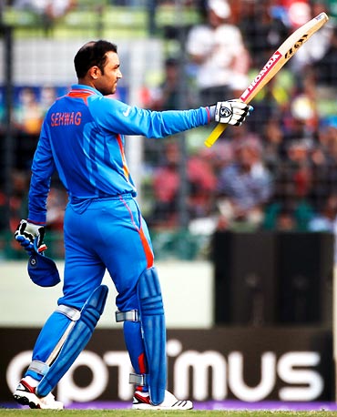 Virender Sehwag celebrates after his completing his century