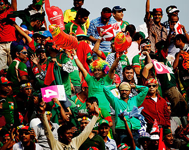 Bangladesh cricket fans soak in the fun during the opening game of the Cricket World Cup between Bangladesh and India at the Shere-e-Bangla National Stadium on Saturday
