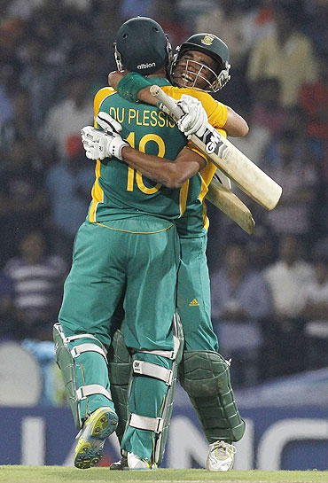 South Africa's Faf du Plessis hugs teammate Robin Peterson (right) after defeating India
