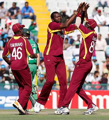 West Indies' Suliman Benn celebrates with teammates after picking up the wicket of Ireland's Niall O'Brien