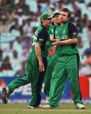 Ireland players celebrate after a fall of a wicket