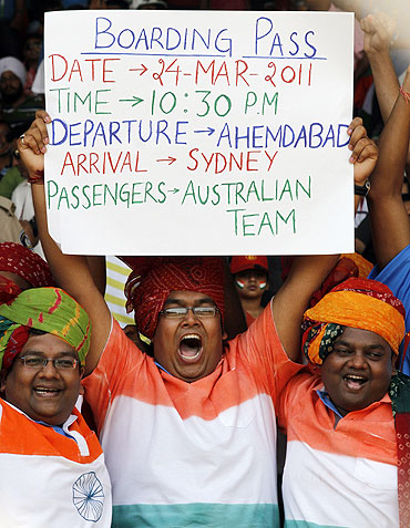 Indian cricket fans hold up a banner during the quater-final match between India and Australia in Ahmedabad on Thursday