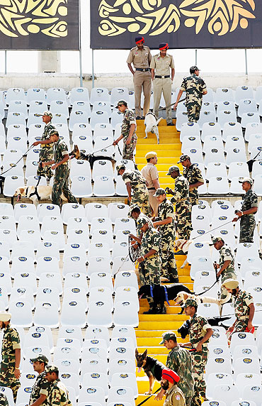 Indian security personnel search the stadium with sniffer dogs prior to the start the second semi-final
