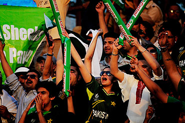 Pakistan cricket fans cheer their team during the second semi-final between India and Pakistan
