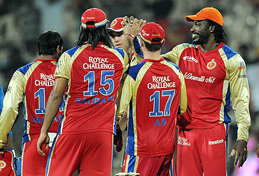 Royal Challengers Bangalore players celebrate after defeating Mumbai Indians on Friday