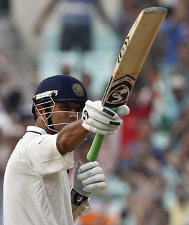 Dravid acknowledges the applause after posting his century