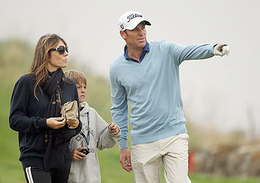 Shane Warne with Elizabeth Hurley and her son Damian at the Kingsbarns Golf Links, in Kingsbarns, Scotland, on Saturday