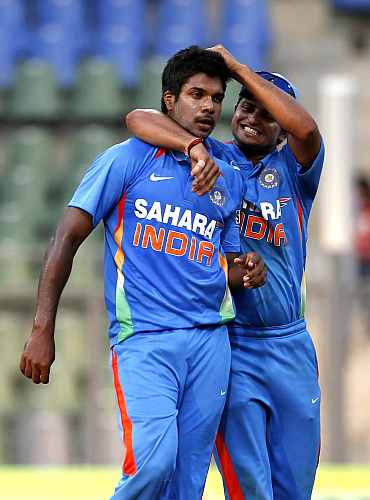 Varun Aaron celebrates after picking up a wicket