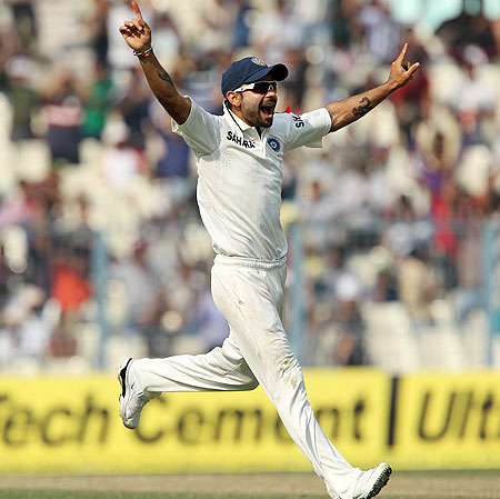 Virat Kohli celebrates the wicket of Alastair Cook
