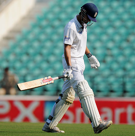 Alastair Cook walks back after being wrongly dismissed by Ishant Sharma