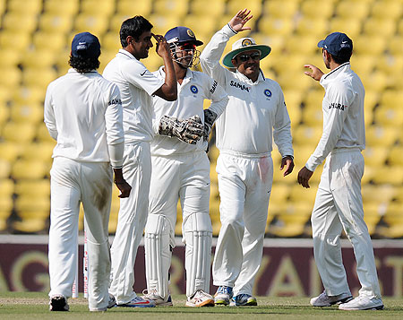 Ravichandran Ashwin celebrates with teammates after claiming the wicket of Jonathan Trott