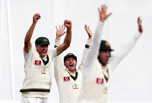 Australia's Michael Hussey (left), captain Michael Clarke and Phil Hughes celebrate