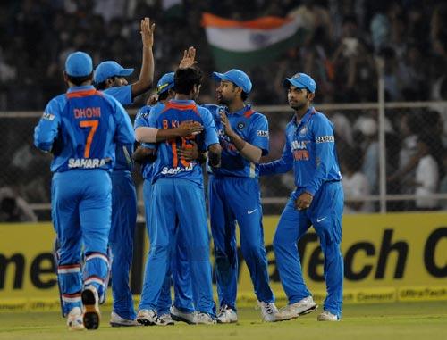 Indian players celebrate after picking up a wicket