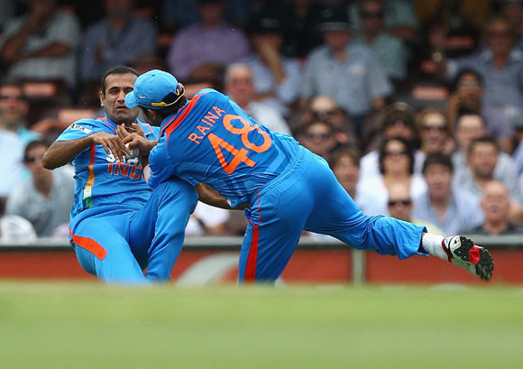 Suresh Raina of India collides with Irfan Pathan of India after Raina took a catch to dismiss David Warner of Australia
