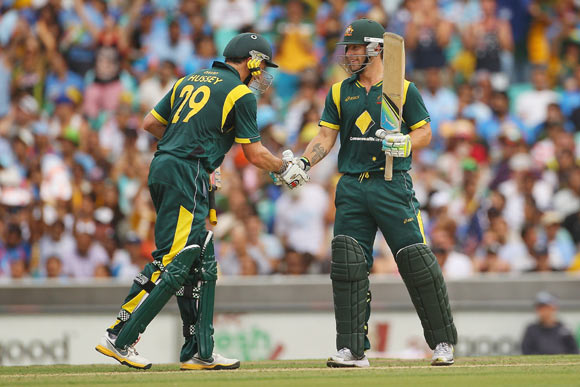 Matthew Wade of Australia is congratulated by team mate David Hussey after scoring fifty runs during the One Day International match