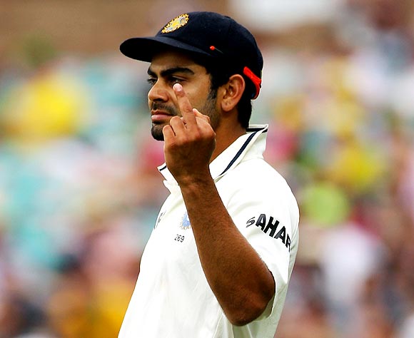 Virat Kohli gestures with his middle finger to the crowd