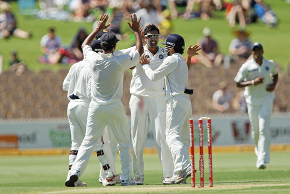Ravichandran Ashwin (C) celebrates with team mates after getting the wicket of Shaun Marsh