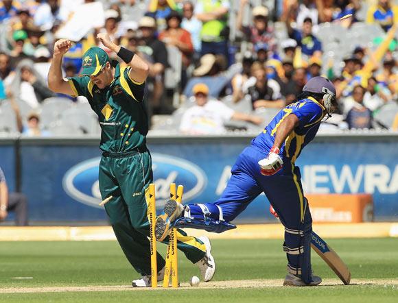 Daniel Christian of Australia celebrates as a direct hit from team mate David Hussey runs out Mahela Jayawardene