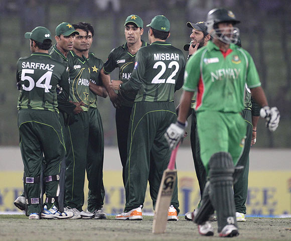 Bangladesh Tamim Iqbal (right) leaves the field as Pakistan's fielders celebrate