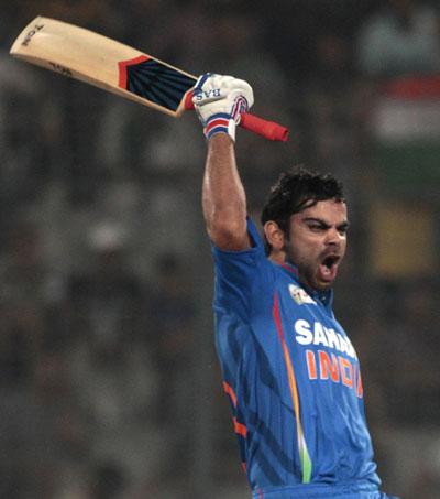 Virat Kohli celebrates after completing his century