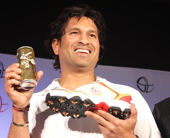 Sachin Tendulkar with the limited edition Coca-Cola Golden Can and the golden shoe launched by Adidas to celebrate his 100th century in international cricket