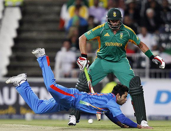 South Africa's Jacques Kallis (back) looks on as India's vice captain Virat Kohli misses a catch during their one-off Twenty20 international cricket match in Johannesburg on Friday