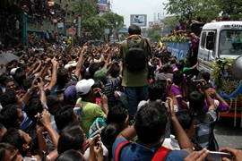 Fans gather on the street to welcome the KKR team