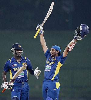 Sri Lanka's Tillakaratne Dilshan (right) celebrates after scoring a century as teammate Angelo Mathews looks on, during their third ODI against New Zealand on Tuesday