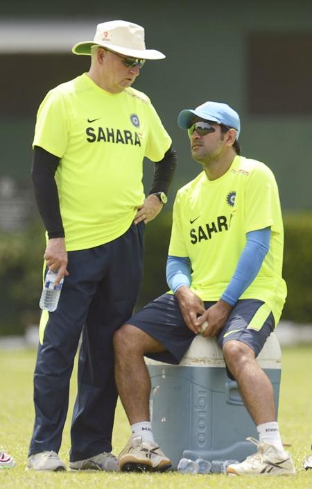 India's coach Duncan Fletcher speaks with captain Mahendra Singh Dhoni at a   training session