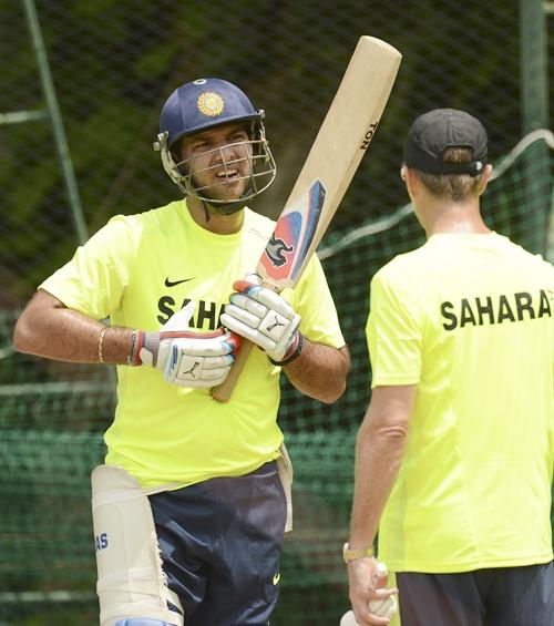 Yuvraj Singh (left) speaks to fielding coach Trevor Penney during a training session