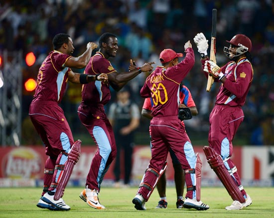Chris Gayle (right) celebrates with team-mates after beating New Zealand in the Super Over