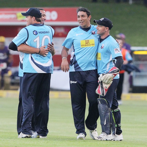 Auckland Aces teammates celebrate with Azhar Mahmood (second from right)