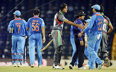 Afghanistan's Shapoor Zadran (centre) greets India's Yuvraj Singh after their losing their match on Wednesday