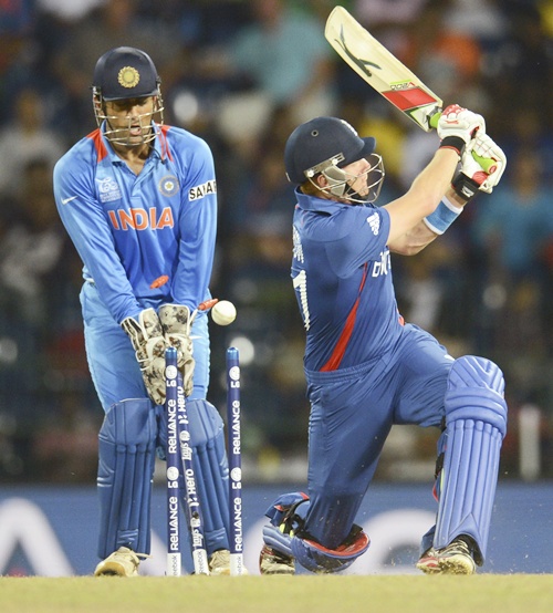 England's Jonny Bairstow (right) is bowled as India's Mahendra Singh Dhoni   looks on