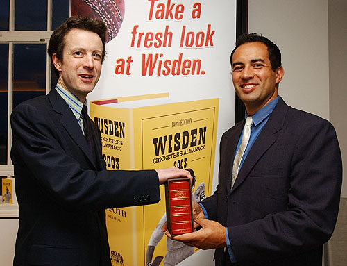 Tim De Lisle (left) editor of the 140th edition of the Wisden Cricketers' Almanac presents England Cricketer Adam Hollioake with a special copy of the Almanac to mark his award as one of five cricketers of the year, at the Launch of the Wisden Cricketers' Almanac on April 29, 2003. It was for the first time in its history that the book had used a photograph on its front cover