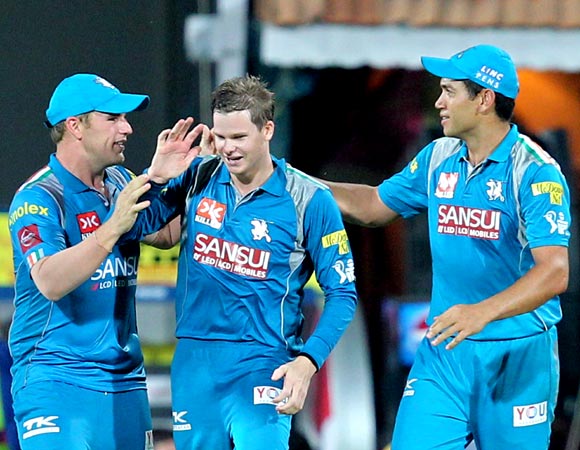 Steven Smith (centre) is congratulated by team mates Aaron Finch and Ross Taylor after taking the catch of Mahendra Singh Dhoni