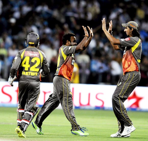 Amit Mishra is congratulated after taking the wicket of Bhuvneshwar Kumar