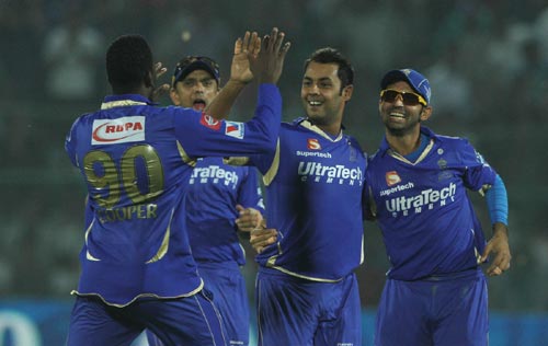 Rajasthan Royals players celebrate after picking a wicket