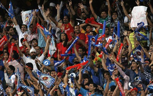 Fans celebrate a fall of wicket