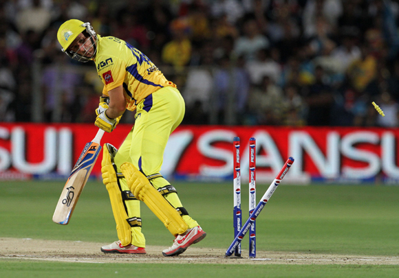 Chennai Super King player Michael Hussey gets bowled